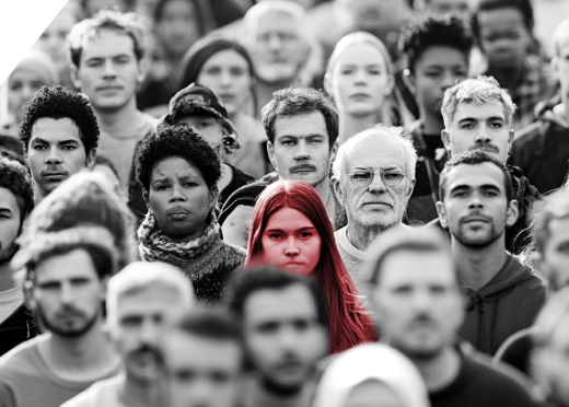 A crowd of faces walking down a city street, with one young woman’s face highlighted in a soft red. [109]
